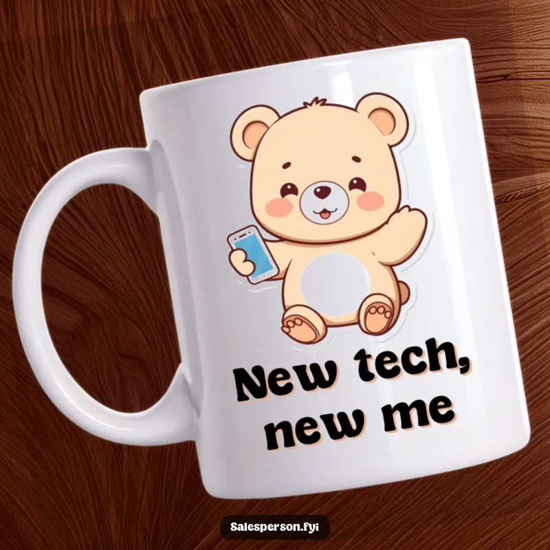 Funny mug featuring a small bear enthusiastically presenting a shiny new gadget with a big smile.