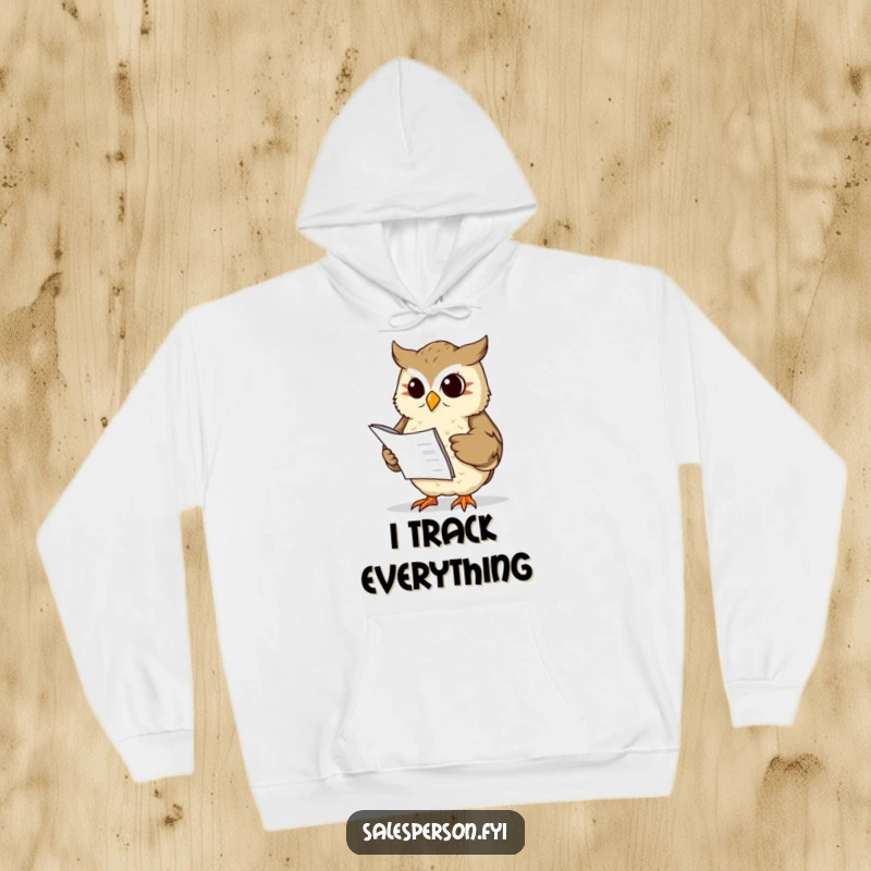 Funny wise owl with a ledger nods sagely on a warm hoodie, a symbol of financial prudence, a funny gift.