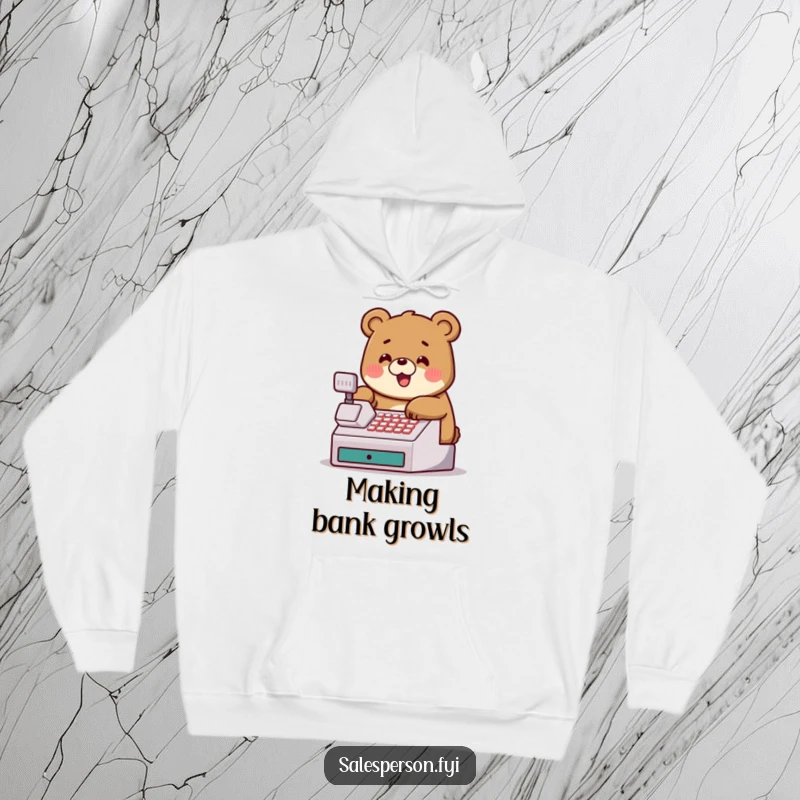 Funny hoodie featuring a jovial bear tapping a cash register, perfect for warm feelings and financial humor.