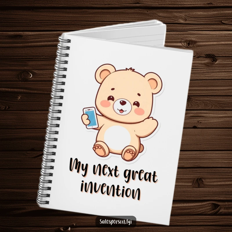Funny notebook cover showing a small bear enthusiastically presenting a shiny gadget with a welcoming smile.